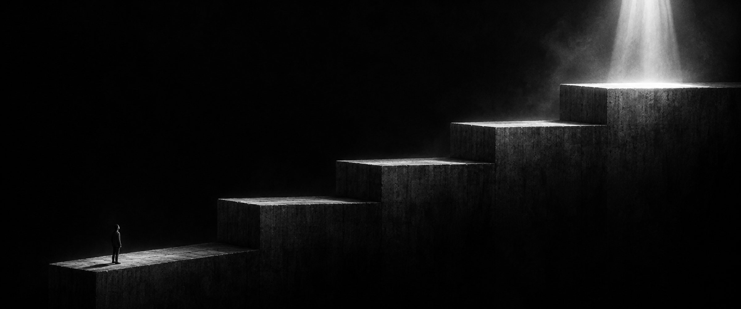 a tiny figure at the foot of five concrete steps rising into light